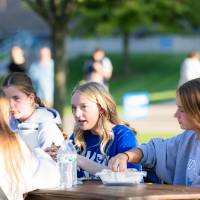 Students eating food at a table.